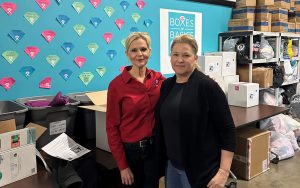 Heather Burke and Kimberly Bradford volunteering with Boxes of Basics